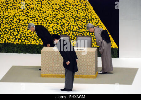 Tokyo, Japan. 15th Aug, 2013. Emperor Akihito, left, accompanied by Empress Michiko and Prime Minister Shinzo Abe, foreground, takes a deep bow to the altar during a ceremony in Tokyo marking the 68th anniversary of Japan's surrender in World War II on Thursday, August 15, 2013. Credit: Kaku Kurita/AFLO/Alamy Live News Stock Photo