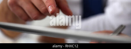 Male arm point finger using tablet pc display Stock Photo