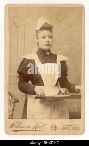 Victorian Carte de Visite of Victorian Parlour Maid, Victorian servant, carrying a tray, with a teacup on it, William Hull studio, Upper Clapton, London, dated Sept.1894 Stock Photo