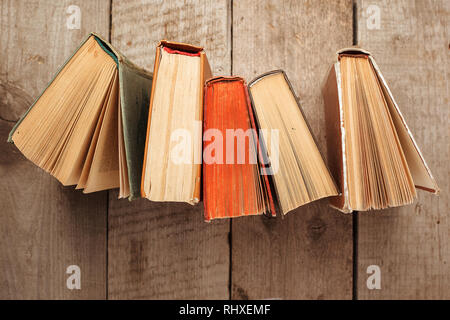 various old books on wooden background, concept of knowledge, leisure time, university still life Stock Photo