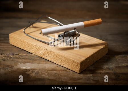 Cigarette on a mouse trap Stock Photo