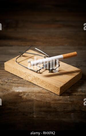 Cigarette on a mouse trap Stock Photo