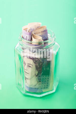 English Twenty Pound notes stuffed in a jam jar. Stock Photo