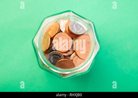 British coins in a jar viewed from above. Stock Photo