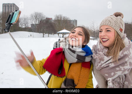 Two women taking a 'snow selfie' in Castle Park, Bristol, UK Stock Photo