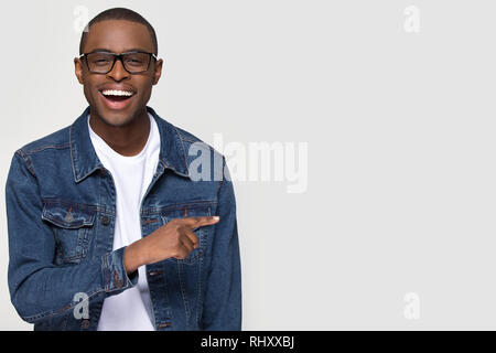 Happy excited african man laughing pointing finger at copy space Stock Photo