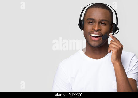 Smiling african american man wearing wireless headset looking at camera Stock Photo