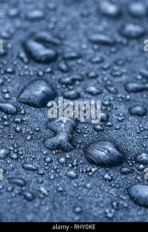 Frozen water droplets on a black car. Stock Photo