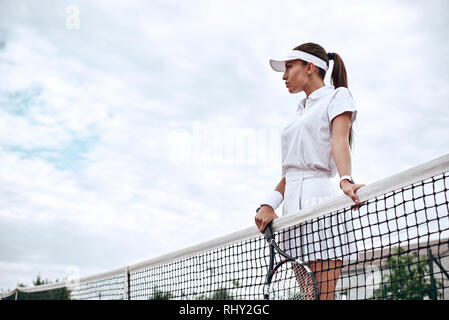 Attractive Female Tennis Player Stands at the Net on Court Stock Photo -  Alamy