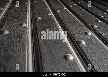 Texture of old wooden plank gate door with iron rivets Stock Photo