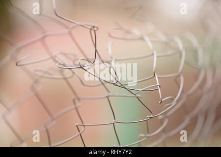 Torn barbed wire bent. Damaged fence Stock Photo