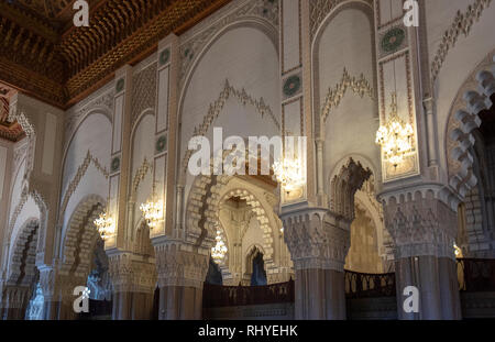 Inside Hassan II Mosque interior corridor with columns. Arabic arches, ornaments, chandelier and lighting. Casablanca, Morocco the largest mosque Stock Photo