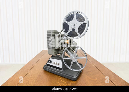 Vintage 8mm home movie projector on wood table. Stock Photo