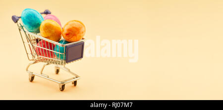 Easter panorama header with shopping cart full of Easter eggs Stock Photo