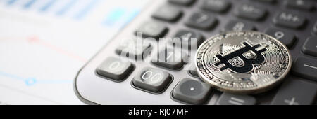 Coin crypto currency bitcoin lies on the keyboard Stock Photo