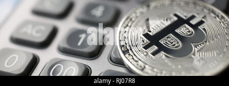 Coin crypto currency bitcoin lies on the keyboard Stock Photo