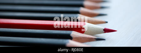 Red pencil standing out from crowd of Stock Photo
