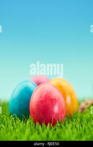Four colorful easter eggs for easter on meadow as greeting cards. Background Stock Photo