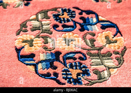 CESENA, ITALY - NOVEMBER 18, 2018: lights are enlightening ancient Eastern rugs for sale in Antiques Fair Stock Photo