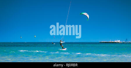 Egypt, Hurghada - 30 November, 2017: The kiter gliding over the Red sea surface. The amazing panoramic view. The lone sportsman among the calm sea water. The outdoor activity. Extreme sport. Stock Photo