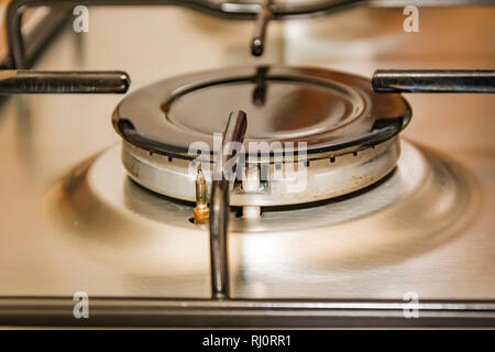 Close-up view of a stove burner in a metal kitchen. interior shot Stock Photo