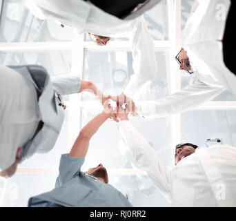 Doctors and nurses in a medical team stacking hands Stock Photo