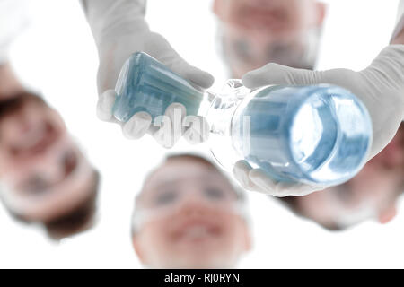 image is blurred. beakers in hand, and scientists Stock Photo