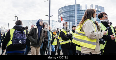 STRASBOURG, FRANCE - FEB 02, 2018: Crowd of people demonstrating in front of European Parliament during protest of Gilets Jaunes Yellow Vest manifestation on the 12 Saturday of anti-government demonstrations