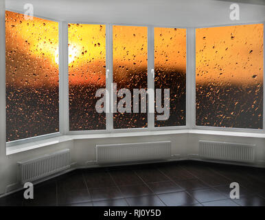 Plastic windows overlooking beautiful golden sunset. View from home window at sunset. Golden sunset outside window. Evening outside window. Modern win Stock Photo