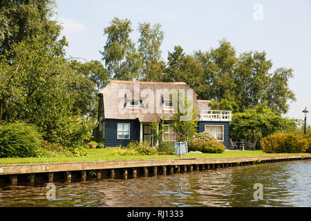 The thatched roof house with beatiful garden in fairytale village Giethoorn in The Netherlands. Stock Photo