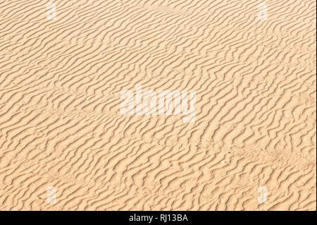 Natural textures of the surface of beach sand. Waves on the sand as background Stock Photo