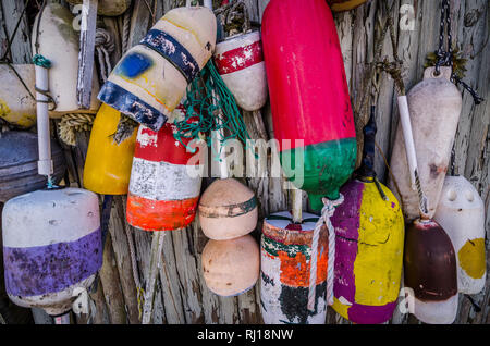 Old weathered bouys attached to a wooden shed on Cape Cod Stock Photo