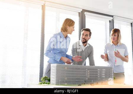Business professionals planning over project at desk in office Stock Photo