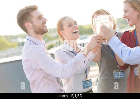 Businessman colleagues toasting wineglasses during success party at terrace Stock Photo
