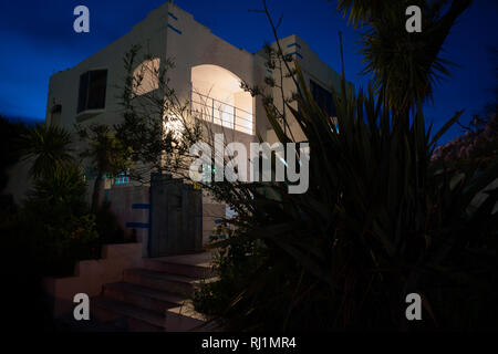 Deco style house spooky in darkness of night from street Stock Photo