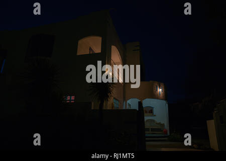 Deco style house spooky in darkness of night from street Stock Photo