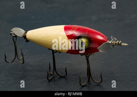 An old wooden fishing lure equipped with three treble hooks for catching  predatory fish. From a collection of vintage and modern fishing tackle. North  Stock Photo - Alamy