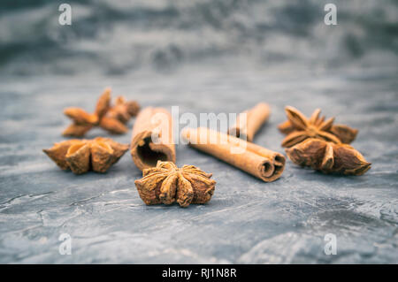 Star anis and cinnamon sticks on vintage dark background. Selective focus Stock Photo