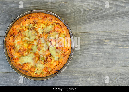 Pie with vegetables and cheese in the pan on a vintage grey wood rustic background Stock Photo