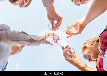 Directly below view of business colleagues toasting wineglasses during success party Stock Photo
