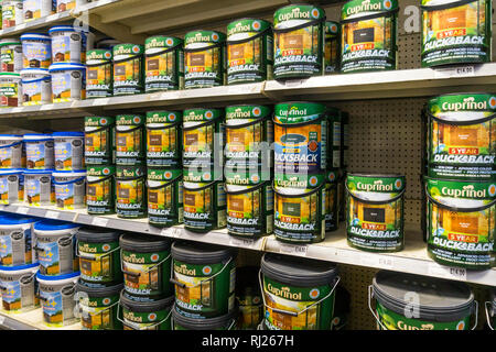 Tins of Cuprinol Ducksback weatherproof paint for sale in a DIY store. Stock Photo