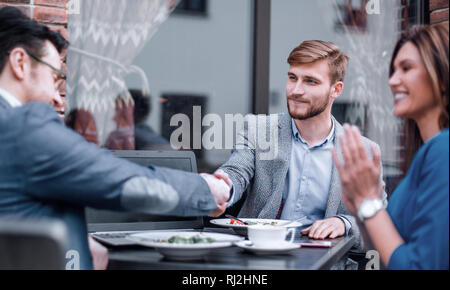 business partners greet each other in the cafe. Stock Photo