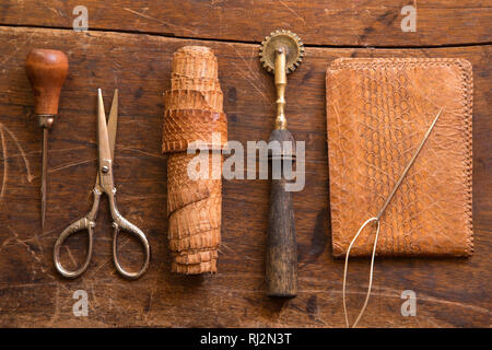 Leather craft tools on a wooden background Stock Photo