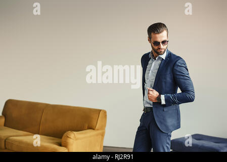 Portrait of stylish and attractive bearded businessman in sunglasses and classic suit. Fashion look. Business style. Stock Photo