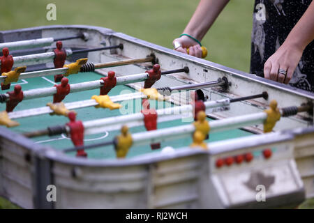 Buenos Aires, Argentina - February 2, 2019: Unidentified hands of a girl playing argentine foosball table called metegol in Buenos Aires, Argentina Stock Photo