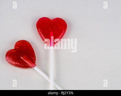 Two heart-shaped lollypops. Valentine's day background. Stock Photo