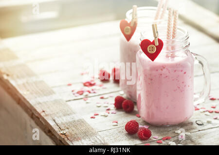 Homemade smoothie with raspberry in jars. Love, eating or valentine's day concept