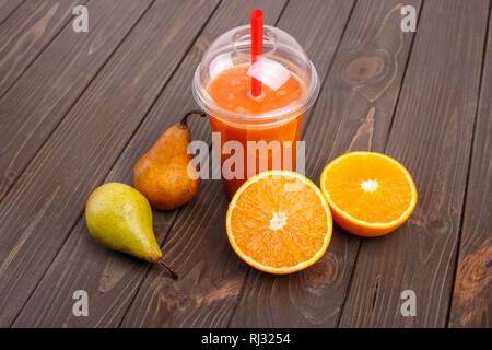 orange detox coctail with oranges and pears lies on wooden table Stock Photo