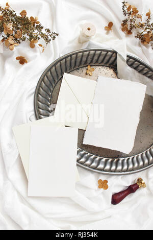 Styled stock photo. Winter, fall wedding, birthday table composition. Stationery mockup scene. Greeting cards, envelopes, dry hydrangea flowers. Silve Stock Photo