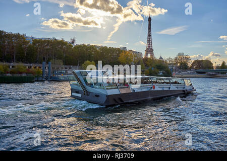 Tourist Boat Passes By The Eiffel Tower During A Bright Autumn Afternoon Stock Photo